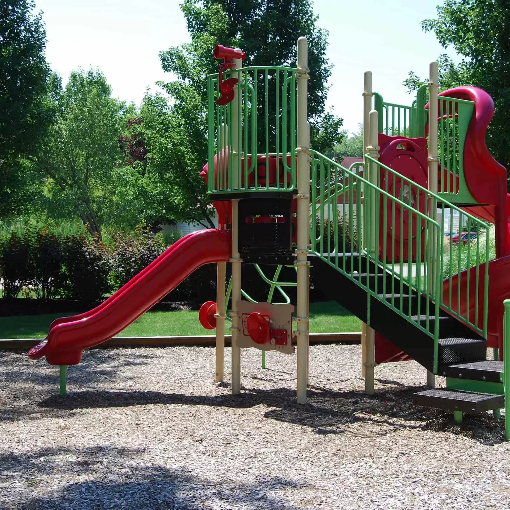 A playground with slides for the children in the apartment community.